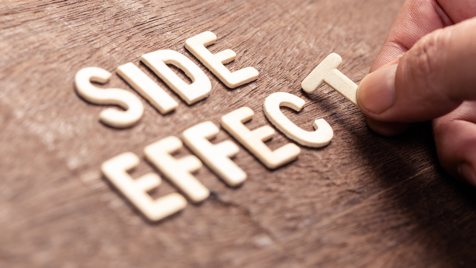 "Side Effect" being spelled out in wood letters.