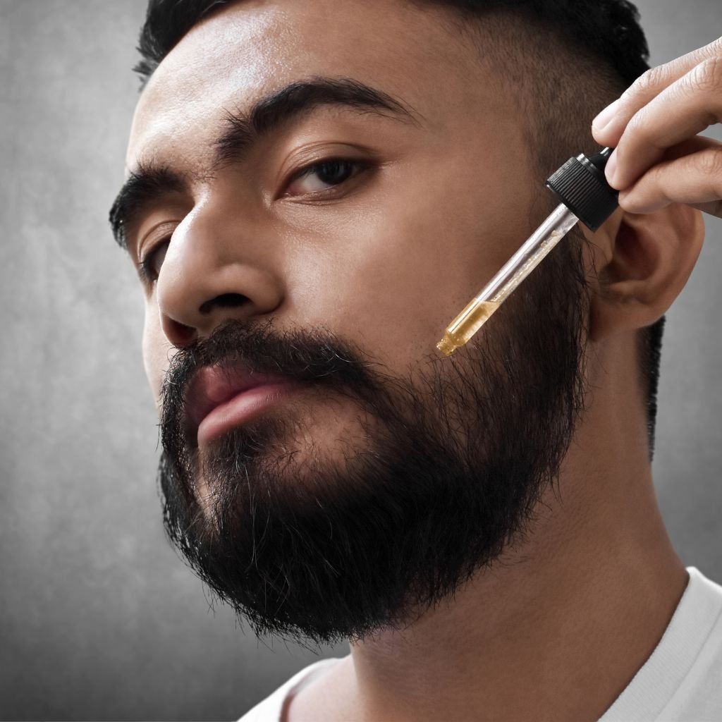 A man applying beard oil.